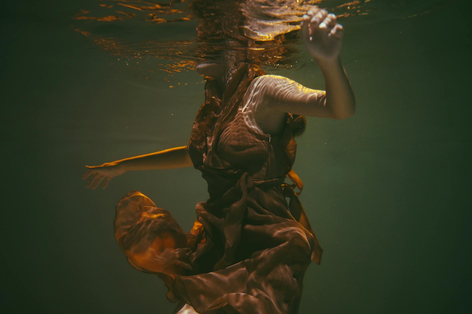 A serene woman in a light-filled room, practicing gentle movement.